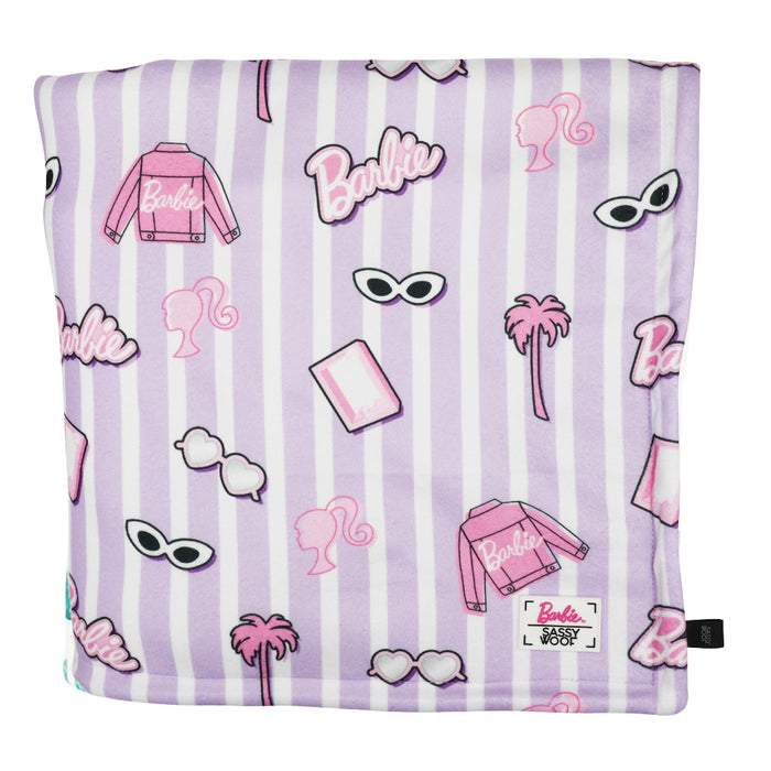 The Sassy Woof Pet Blanket - BARBIE™ Closet Goals features light purple and white stripes with Barbie-themed icons like sunglasses, palm trees, the Barbie logo, pink jackets, and Barbie’s silhouette.