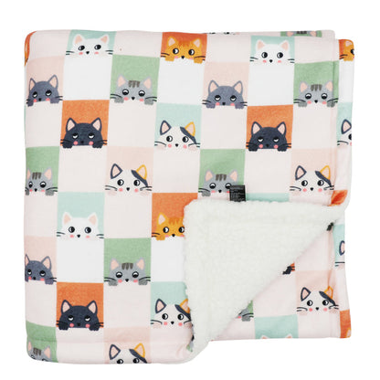 The Sassy Woof Pet Blanket - Smitten Kittens features a colorful checkered pattern with cartoon cat faces and a soft, fluffy white sherpa underside for extra comfort.