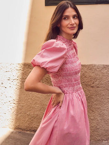 Red stripe midi dress with shirred bodice, puff sleeves, frill neckline and flowing skirt.