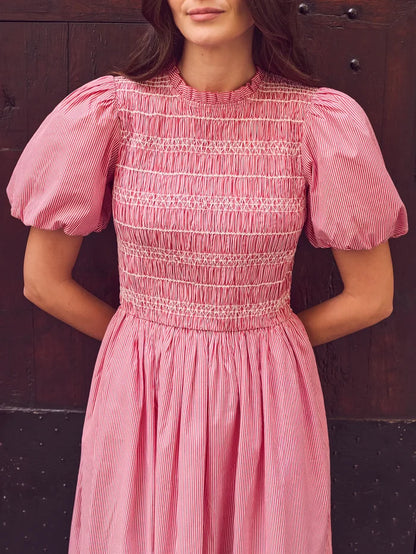 Red stripe midi dress with shirred bodice, puff sleeves, frill neckline and flowing skirt.