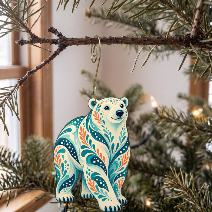 Laser-cut maple wood Polar Bear folk art ornament O249 hanging on a fir branch, made in USA