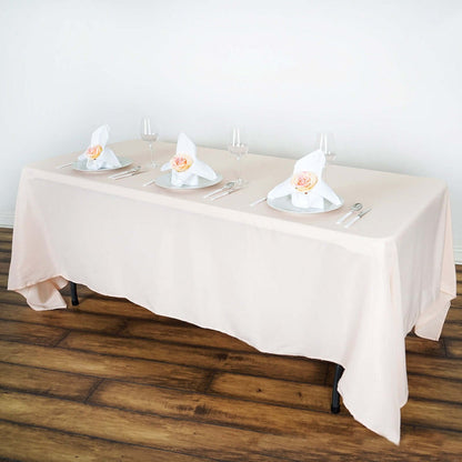 Elegant dining table set with napkins and floral accents.