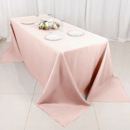 Pink tablecloth draped elegantly over a table set for dining.