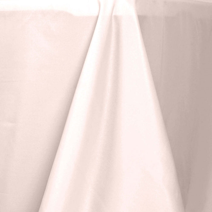 Elegant light pink tablecloth draping over a table edge.