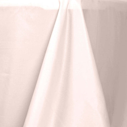 Elegant light pink tablecloth draping over a table edge.