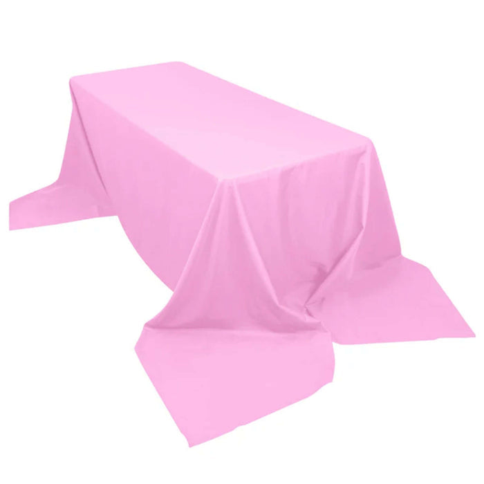 Pink tablecloth draped over a rectangular table in studio isolation shot