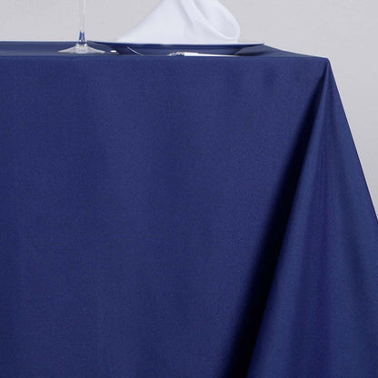 Navy tablecloth draped elegantly over a table with a white napkin.