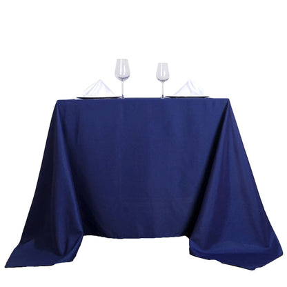 Navy tablecloth with white napkins and glasses on a table