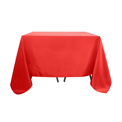 Red tablecloth on a table with smooth draping.