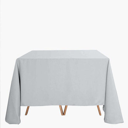 Gray tablecloth draped over a wooden table on a white background