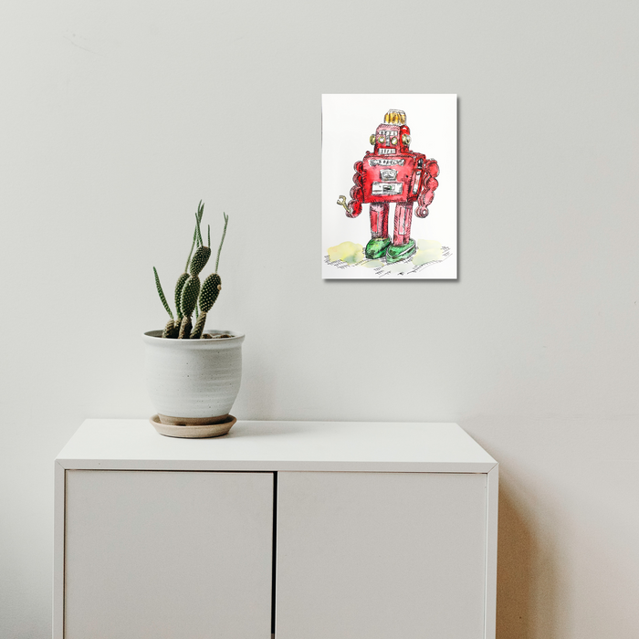 The artwork 'Robot Rouge' by Andrew Chan features a whimsical watercolor and ink illustration of a vintage-style robot in bright red tones. The robot has a boxy body with mechanical details, standing against a minimalist white background with subtle green ground shading. The loose, expressive brushwork creates a playful, retro-futuristic aesthetic at 12x9 inches.