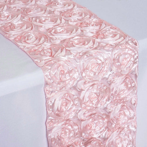 Pink satin table runner with 3D rose pattern.
