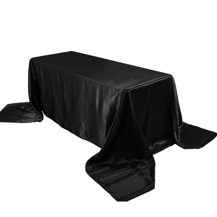 Black satin tablecloth draped elegantly over a rectangular table