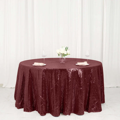 Burgundy sequin tablecloth draped elegantly on a round table