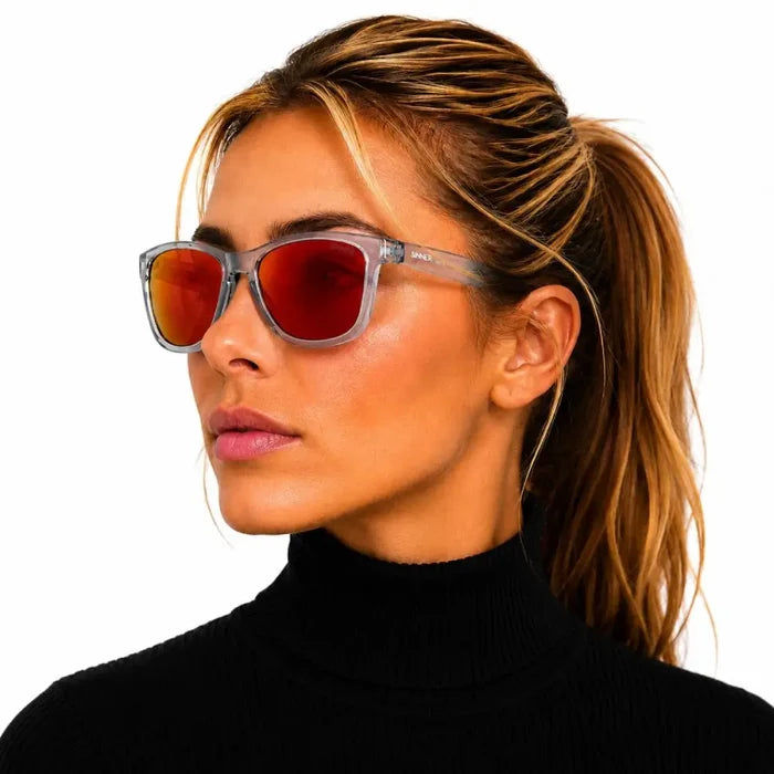 Woman looking to the side whilst wearing Sinner Pataua Polarised Sunglasses in grey on a white background