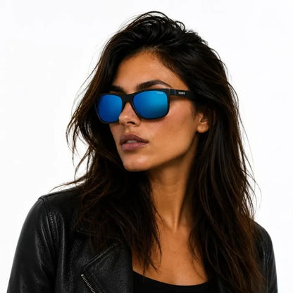 Woman with her head turned to the side wearing Sinner Rockford polarised sunglasses in matte black colour and a black leather jacket on a white background