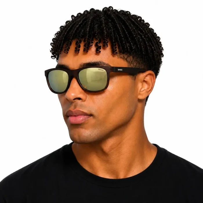 Man with his head turned to the side wearing Sinner Rockford polarised sunglasses in matte brown colour on a white background