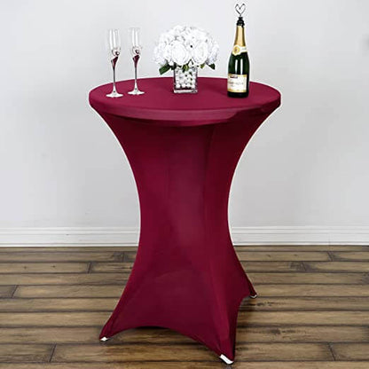Maroon cocktail table with champagne and glasses, styled for events.