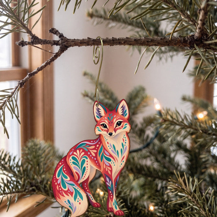 Laser-cut maple wood Swift Fox folk art ornament O256 hanging on a fir branch, made in USA