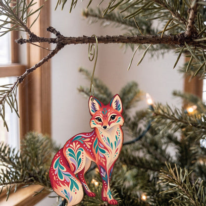 Laser-cut maple wood Swift Fox folk art ornament O256 hanging on a fir branch, made in USA