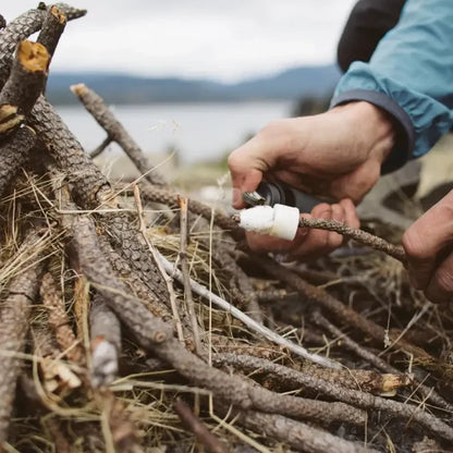 Zippo Easy Spark Tinder being used with a lighter to ignite kindling fopr a camp fire
